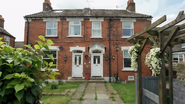 High resolution 4K travel footage displaying the charming exterior of a historic red brick townhouse row in Dublin Ireland highlighting colorful wooden doors wrought iron railings and classic Irish