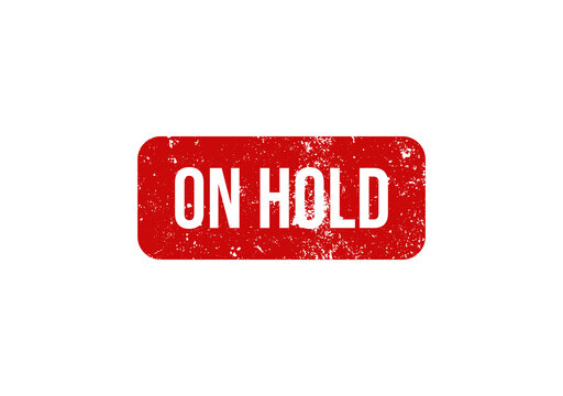 Red grunge rubber stamp with the text on hold isolated on a white background for business document marking.