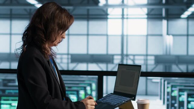 System administrators use laptop in a server room to update storage arrays and maintain system performance, combining server virtualization, coffee workflow and infrastructure reliability.