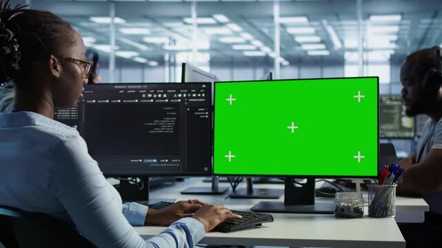 Employees monitoring energy consumption across server rigs using chroma key PC from a secondary camera angle while highlighting data protection, network security and infrastructure risk.