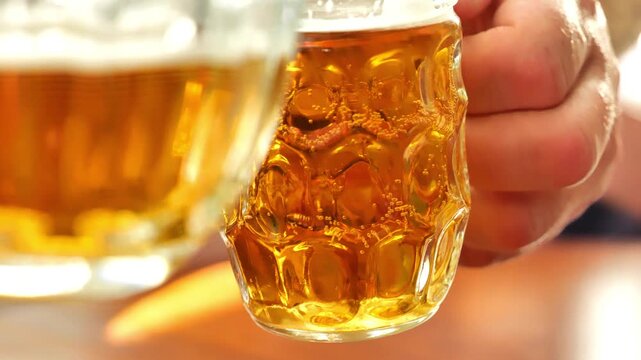 Beer for Oktoberfest Celebration.Two people are drinking beer. They are checking in with their beer mugs. 4k footage