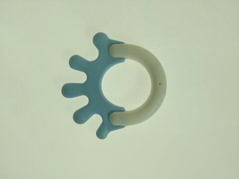 centered blue silicone baby teether with arc handle