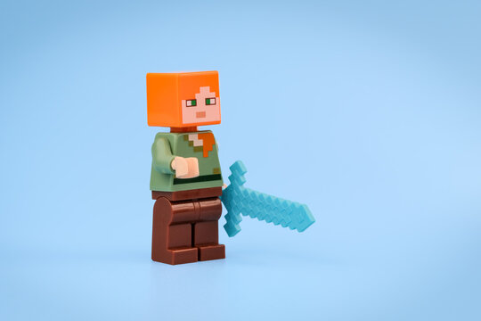 Minecraft Alex toy figure stands holding a translucent blue Diamond Sword against a clean light blue background on Jul 25, 2026 in Jakarta, Indonesia