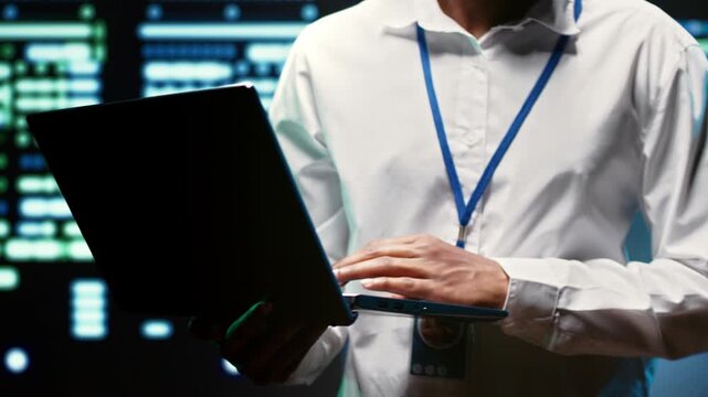 African American engineer verifies redundancy for mainframes in a data storage enterprise, supporting automatic failover, rapid reconfiguration and dependable cluster continuity.