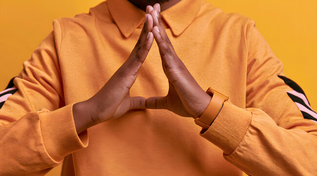 Close-up of a person making a timeout gesture with their hands.