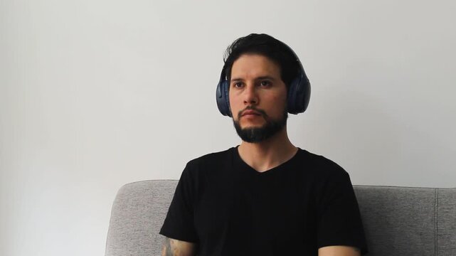Detailed view of a caucasic man listening something into a headset in a concentrating attitude