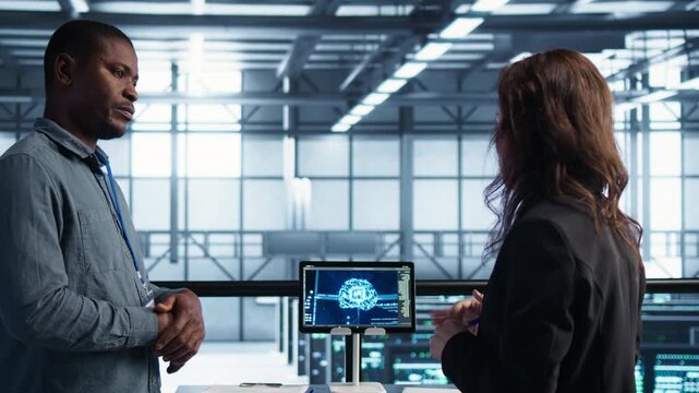 In a server room, engineers use tablet while handling neural networks, predictive maintenance and IT team across infrastructure operations within a controlled technical environment.