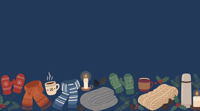 Cozy winter items border illustration with mittens scarves blankets and hot drinks on dark blue background.