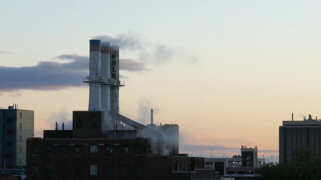 View of Detroit Thermal steam energy utility, historic Willis Avenue Station in Midtown Detroit, Michigan and steam rising from the stacks. Shot during late afternoon in September 2022.