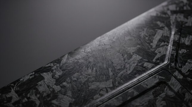 Macro view of black forged carbon composite material surface showing unique marbled texture for high performance engineering parts