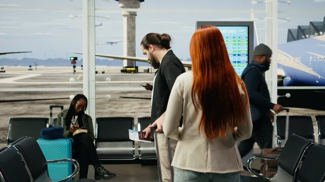 Couple shares a heartfelt hug at an airport gate before departure, facing a long-distance relationship with sadness and emotional separation.