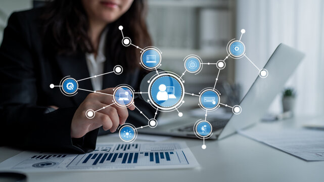 A business professional engages with innovative digital technology in an office setting, utilizing graphical icons to represent networking and data analysis concepts. Tessel