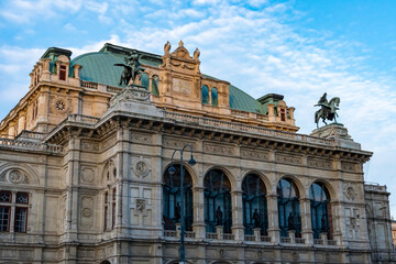 Historic Building with Green Roof and Sculptures Under Blue Sky © iBennn