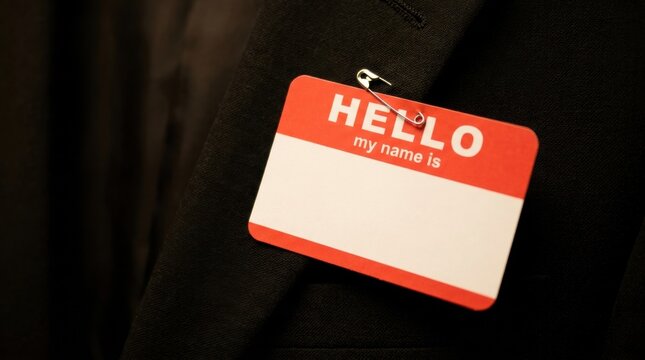 Blank Red Hello My Name Is Name Tag Pinned with Safety Pin on Black Suit Jacket Lapel