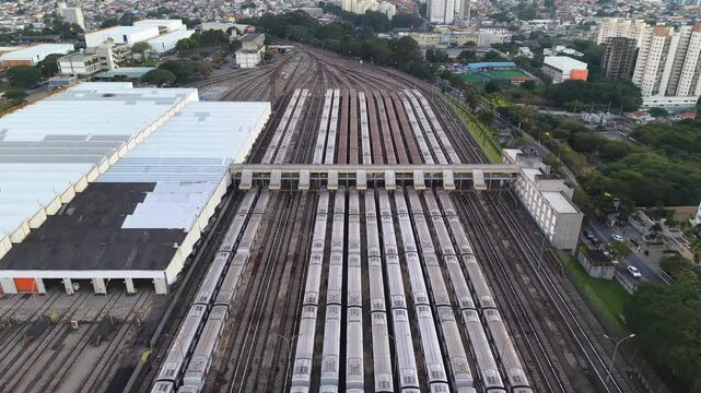 Aerial view of numerous metro trains parked in parallel rows at a railway depot