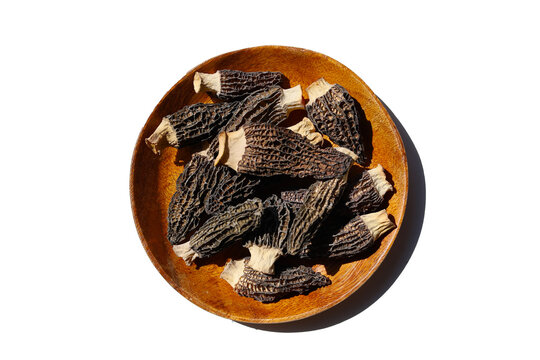 Dried morel mushrooms on white background.