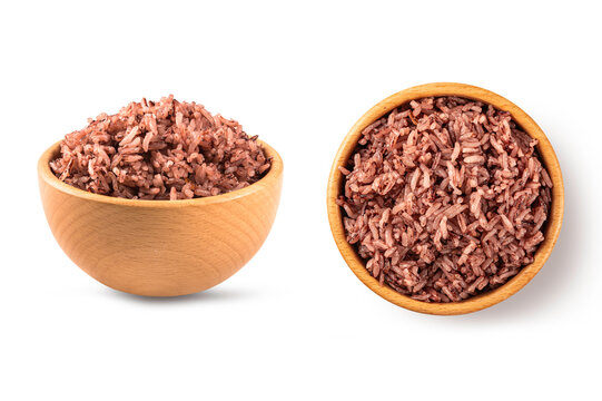 Organic steamed red jasmine rice in side view and top view within natural wooden bowls.  for nutritious food blogs, healthy diet menus, and clean eating concepts
