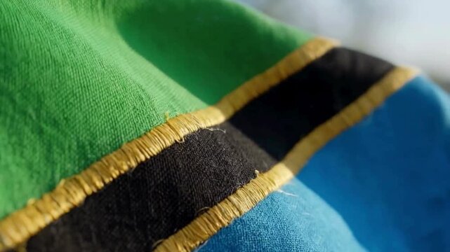 Close-up of Tanzanian Flag with Green, Black, and Blue Colors.