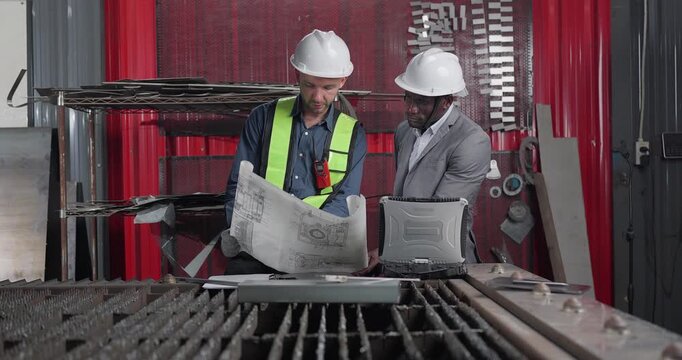 Sales Engineer Briefs Client in QC Workshop on Custom Fabrication Solutions