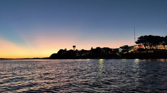 Tranquil Waterfront Sunset & City Lights at Dusk