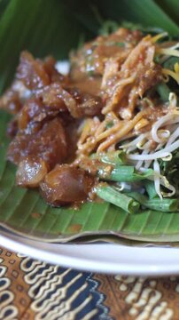 Vertical Close Up of Pecel Koyor, Authentic Indonesian Beef Tendon and Vegetable Salad with Peanut Sauce