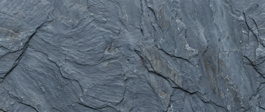 Slate rock texture featuring rugged blue gray surface with natural crack lines creates a dramatic background for design projects