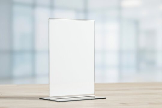 Clear acrylic table sign holder mockup on a wooden desk