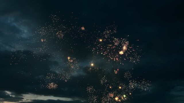 Spectacular fireworks exploding across the evening sky during a festive celebration. Bright colorful bursts create a dramatic holiday atmosphere with copy space.