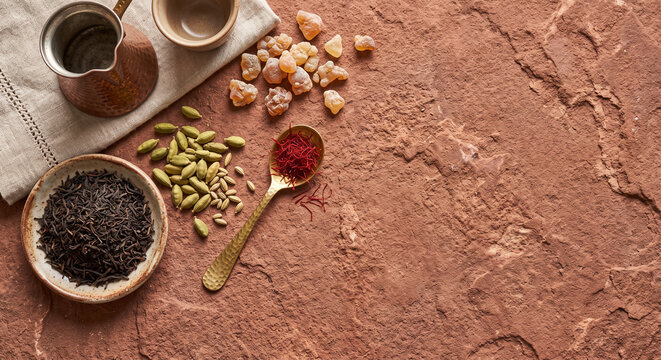 Overhead flat lay of Omani frankincense tea ingredients on red sandstone