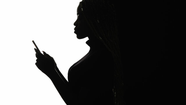 Online communication. Social media. Internet network. Profile silhouette of woman texting message using smartphone isolated on white empty space.