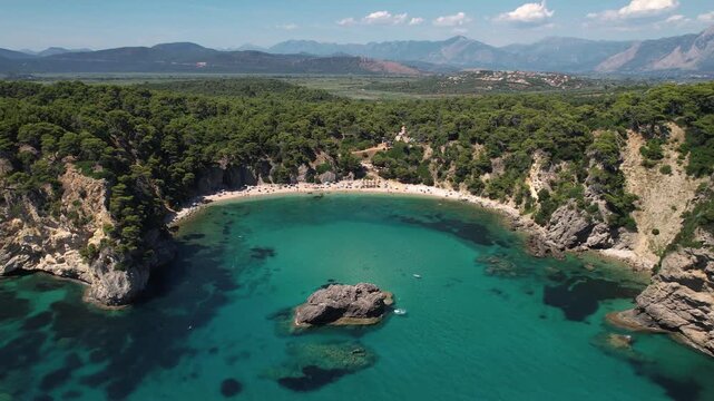 Wide Landscape Shot of Alonaki Fanariou Beach in Preveza Greece, Aerial Reveal Shot of Clear Waters and Rock Island