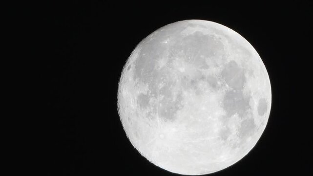 Moon astronomy space capturing a detailed view of the lunar surface with craters and highlights against the pitch black night sky