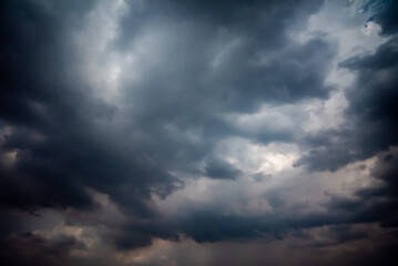 Obraz premium Dark and Moody Thunderstorm Clouds Forming in the Sky Before Heavy Rainfall and Severe Weather, Dark sky with stormy clouds,Dark clouds before a thunder-storm,clouds before rain