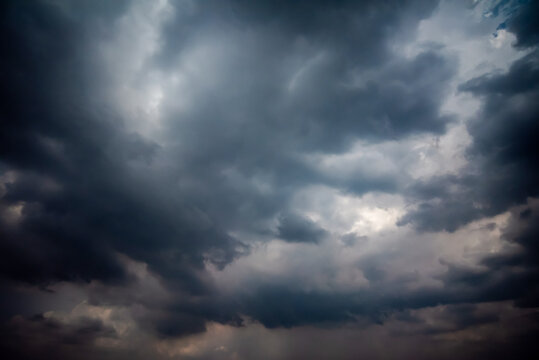 Dark and Moody Thunderstorm Clouds Forming in the Sky Before Heavy Rainfall and Severe Weather,
Dark sky with stormy clouds,Dark clouds before a thunder-storm,clouds before rain