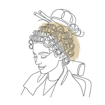 Woman with hair rollers sitting in salon chair.