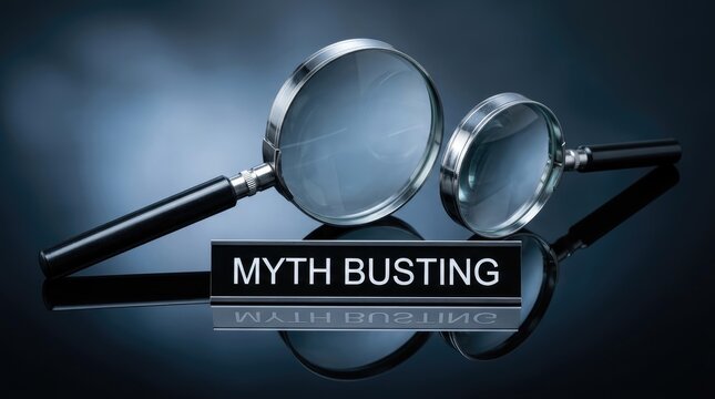 Two shiny magnifying glasses rest behind black desk plate featuring bold white myth busting text