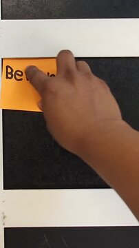 Sticking Note with Word Believe on Door Frame