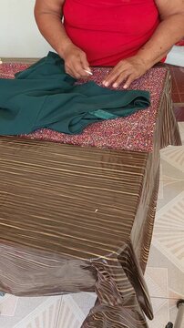 Seamstress Marking Pattern Lines on Dress Fabric