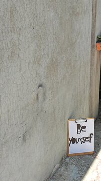 BE Yourself Motivational Note Mounted Next to Gray Wall