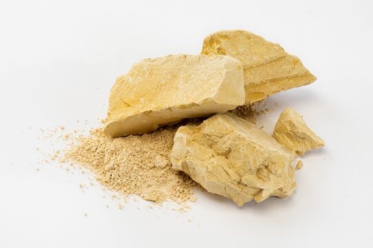 Still Life of Pale Yellow Soil Chunks and Matching Fine Soil Powder
