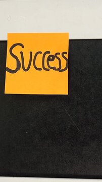 Sticky Note with Word Success on Black Wooden Frame