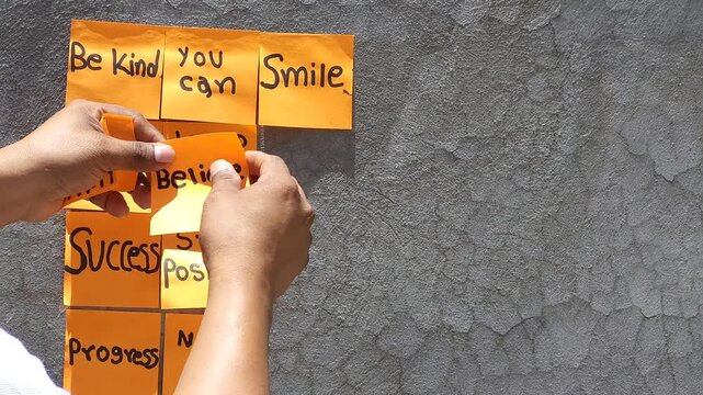 Sticking Multiple Motivational Notes on Rustic Concrete Wall