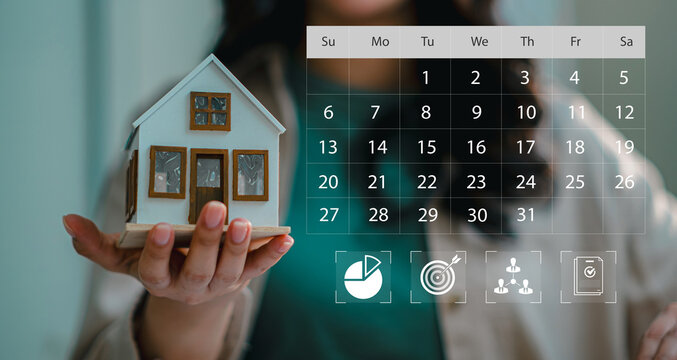 Businesswoman holding model house with virtual calendar schedule overlay and key business performance icons, concept of real estate planning and project timeline