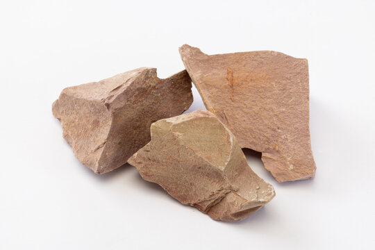 Close-up of Three Broken Light Brown Dry Soil Clods on White Background