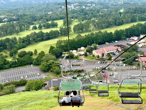 Aerial view from Mount Omuro chairlift over lush green hills and landscape, Izu, Japan