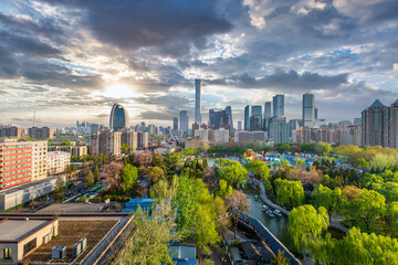 Fototapeta premium Urban greenery and skyscrapers in Beijing, China, are photographed together.