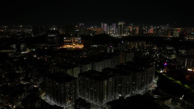 Low light of Jains Carlton Creek apartments with illuminated divya sree building and cityscape at khajaguda, manikonda, hyderabad, telangana, india. night time, push in shot, drone shot, 4k.
