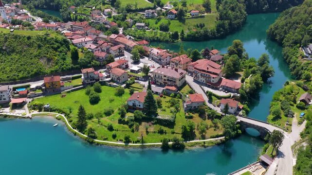 Riverside Town With The Historic Settlement Along The Soča River In Most na Soči In Slovenia. Aerial Drone Shot