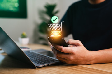 Naklejka na ściany i meble Ecommerce purchase success concept with person holding smartphone and virtual shopping cart checkmark showing online order confirmation payment transaction and digital retail experience