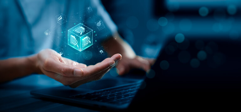 Digital document management concept with hand holding virtual file analytics cube over laptop showing data processing automation search report and business workflow technology